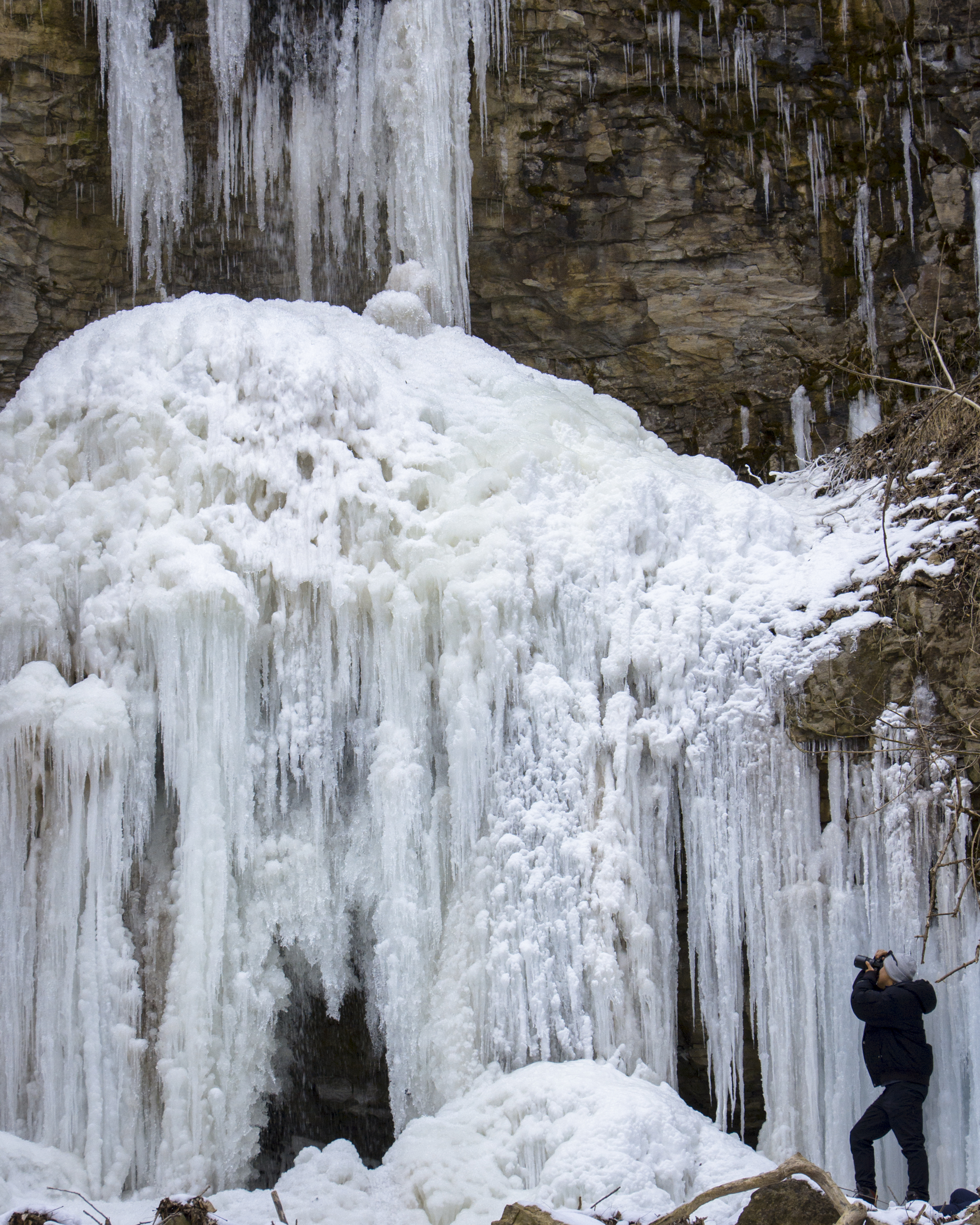 A frozen waterfall with large icicle formations